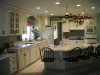 Oak cabinets with bead board island and swivel stools